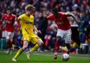 AFC Wimbledon's Jack Rudoni (left) and Charlton Athletic's Diallang Jaiyesimi battle for the ball during the Sky Bet League One match at The Valley, London.