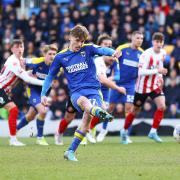 AFC Wimbledon's Luke McCormick (centre) scores their team's first goal during the Sky Bet League One match at The Cherry Red Records Stadium, London.