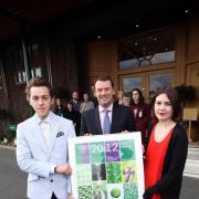A smash: James Jessiman and Danielle Watt show off their official poster with Philip Brook, chairman of All England Lawn Tennis Club