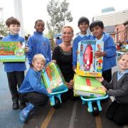 Headteacher Nathalie Bull with pupils from Singlegate Primary School with donated items