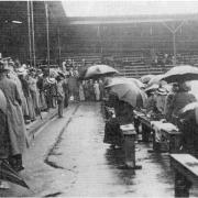 Spectators await dry weather at the Wimbledon championships in Worple Road, 1914.