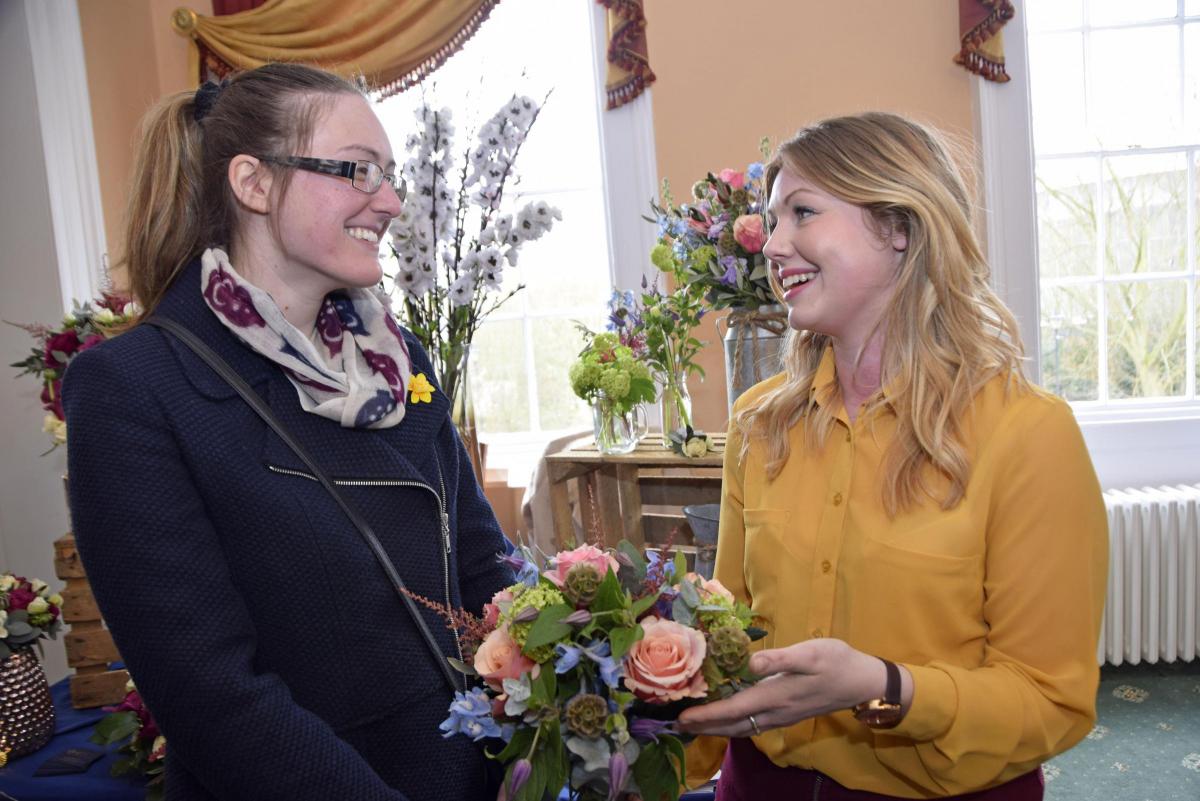 Georgina Heather, on the left, speaks to florist Rosie Welch