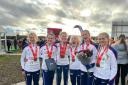 Hercules Wimbledon’s Ellen Weir second from the right holding the flowers with the bronze medal-winning British team