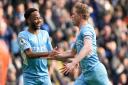 Manchester City's Kevin De Bruyne (right) celebrates with Raheem Sterling after scoring their side's first goal of the game during the Premier League match at Etihad Stadium, Manchester.