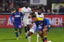 Boreham Wood's Tyrone Marsh (second right) and AFC Wimbledon's Henry Lawrence (right) battle for the ball during the Emirates FA Cup third round match at the LV Bet Stadium Meadow Park, Borehamwood.