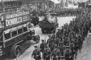 Troops march up Wimbledon Hill Road past Ely’s during the early days of the First World War
