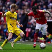 AFC Wimbledon's Jack Rudoni (left) and Charlton Athletic's Diallang Jaiyesimi battle for the ball during the Sky Bet League One match at The Valley, London.