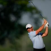 Rory McIlroy hits his second shot on his opening hole, the 10th, in round one of the US PGA Championship (Matt York/AP)
