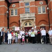 Campaigners protesting the changes outside Wimbledon Library on Monday