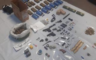 What's suspected to be an explosive powder was discovered among the weapons