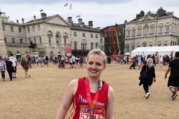 Abbey Bryan with medal after completing London Marathon