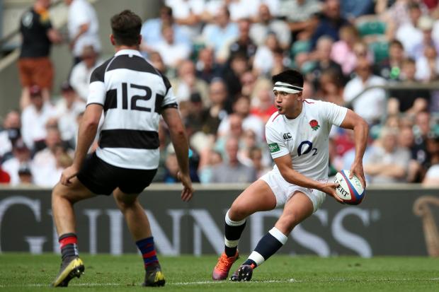 LONDON, ENGLAND - JUNE 02: Marcus Smith of England (L) offloads the ball during the Quilter Cup match between England and Barbarians at Twickenham Stadium on June 02, 2019 in London, England. (Photo by Steve Bardens - RFU/The RFU Collection via Getty